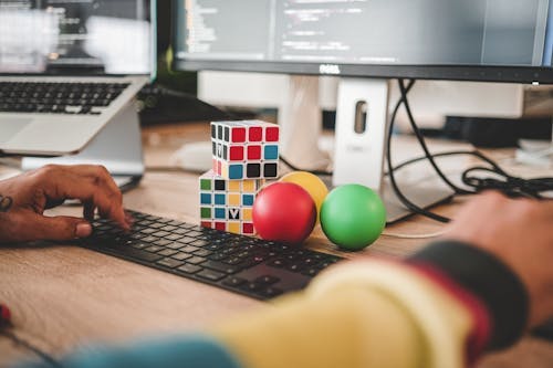 Keyboard, computer screen, and Rubik's cube